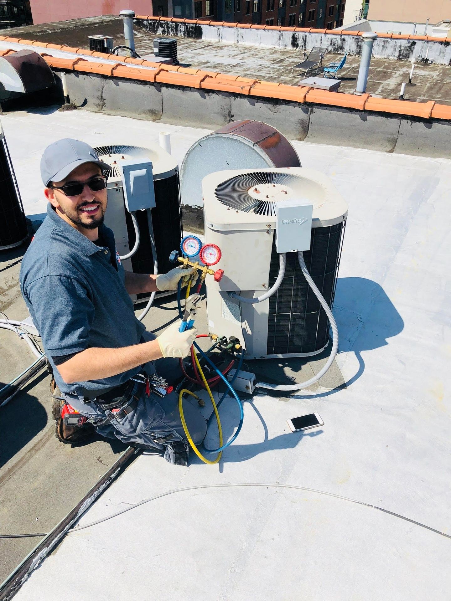 Cheerful young man fixing electrical wall socket